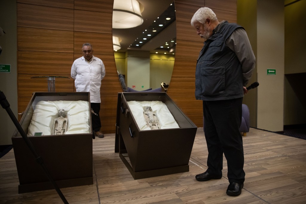 Mexican journalist and UFO expert, Jaime Maussan observes the 'non-human' beings before a press conference, at the Camino Real hotel, in Mexico City, Mexico on September 13, 2023