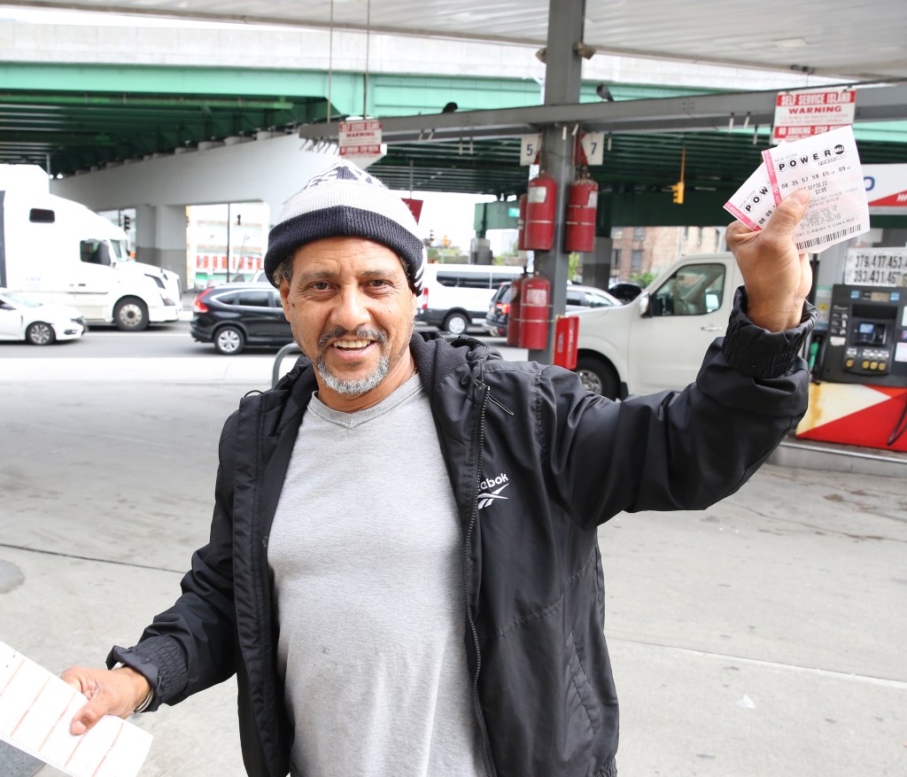 Bronx resident Willie Perez holds his Powerball ticket after purchasing it on Sept. 30, 2023.