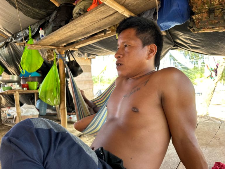 A shirtless man leans back in Bajo Chiquito